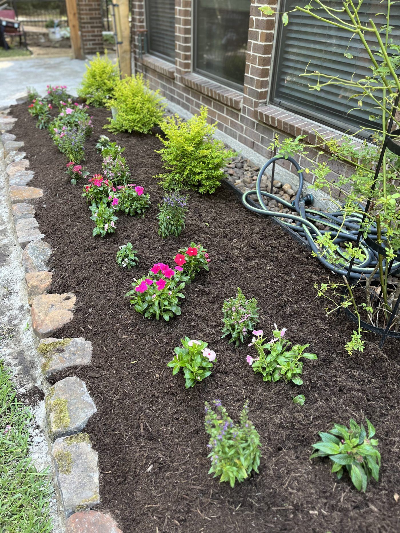 Flower bed installation with stone edging Houston TX