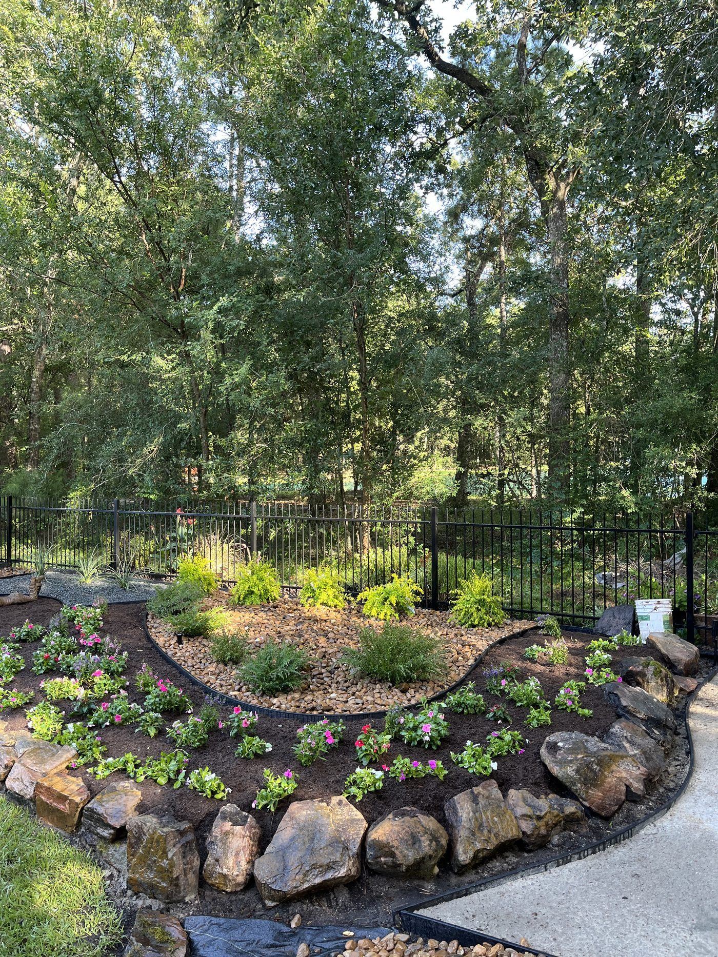 Circular landscape install with flowers and stone border Houston TX